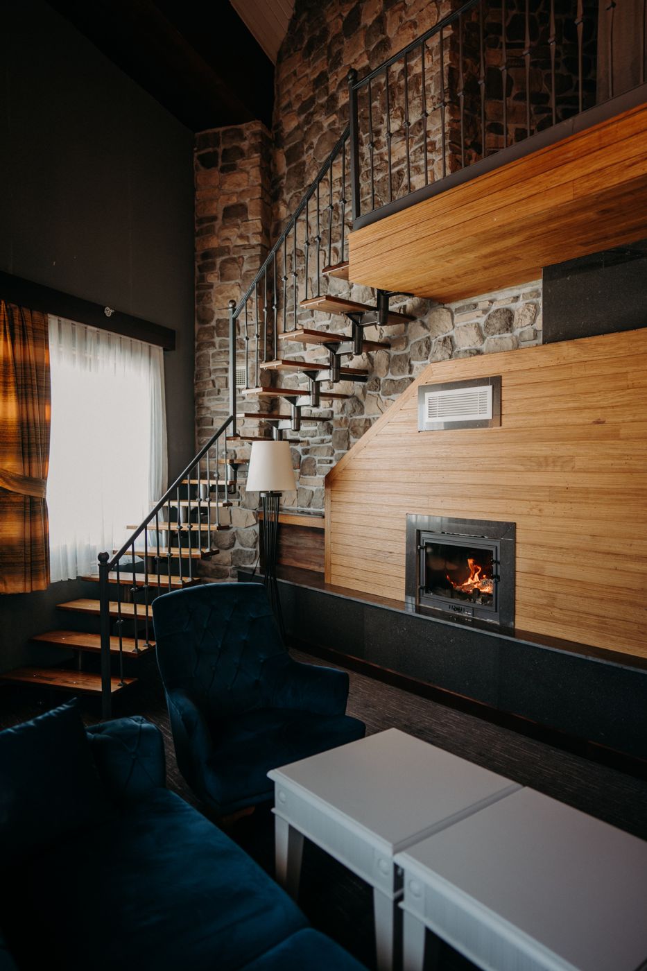 Mirada Del Lago — suite with a steel staircase and fireplace