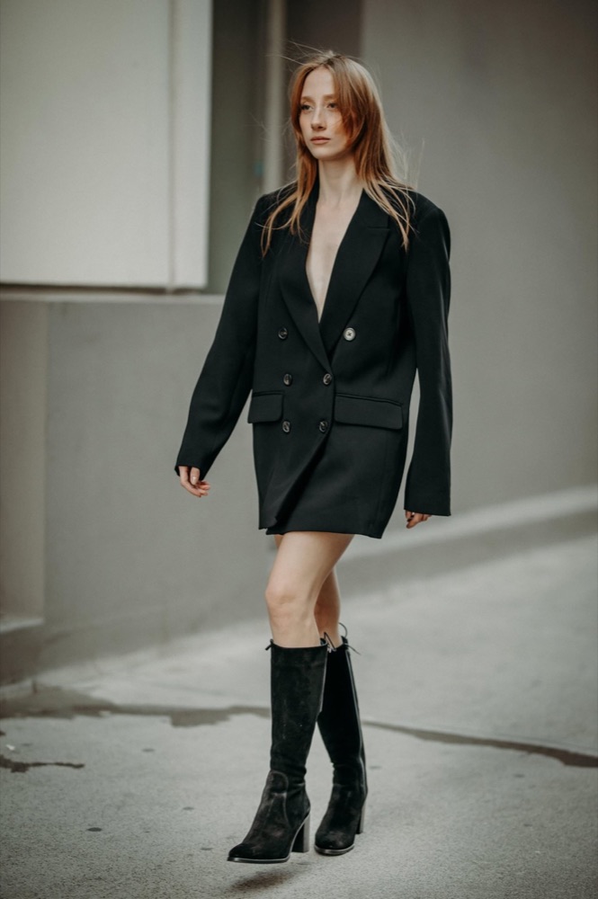 Model walking in a black blazer