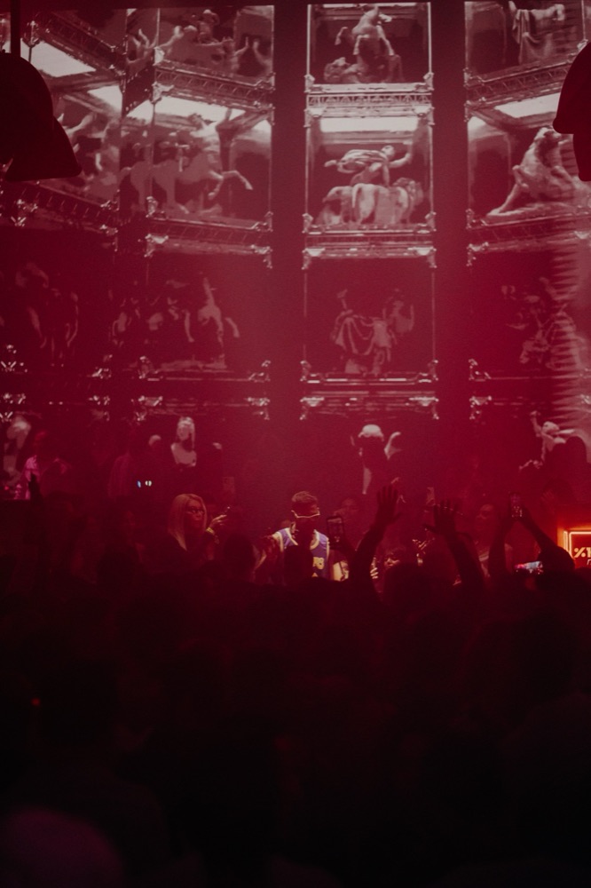 Concert crowd under red stage lights