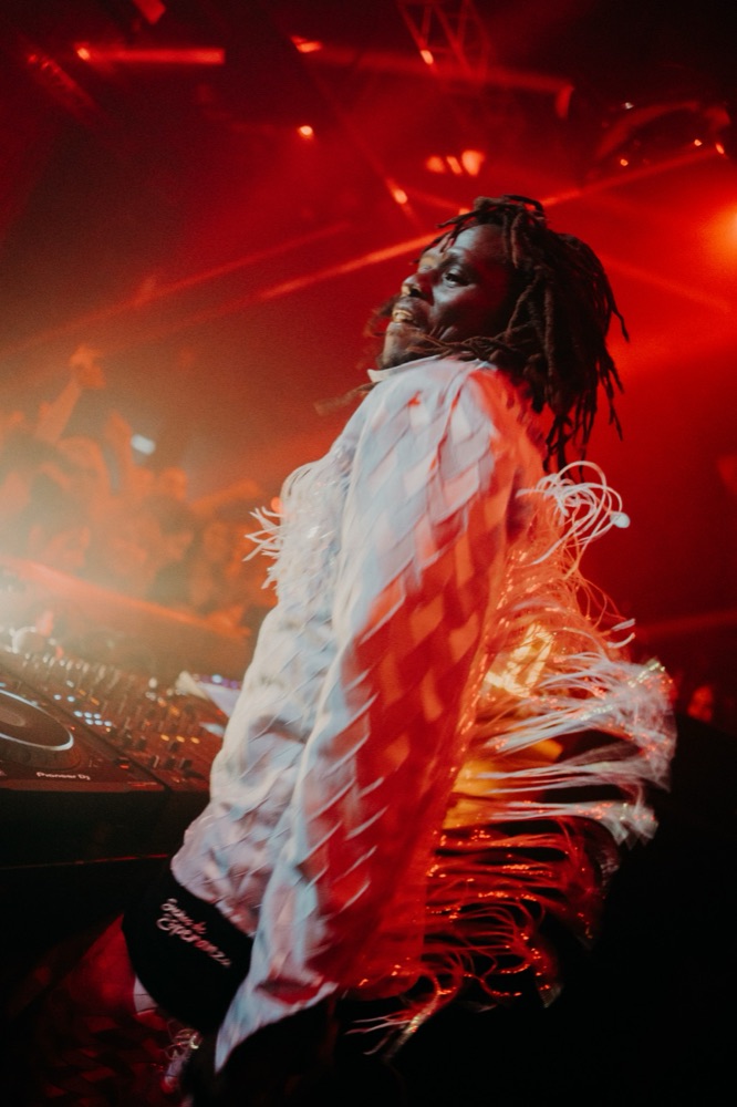 DJ performing under red light