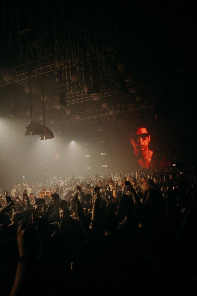 Crowd at a live event with stage projection